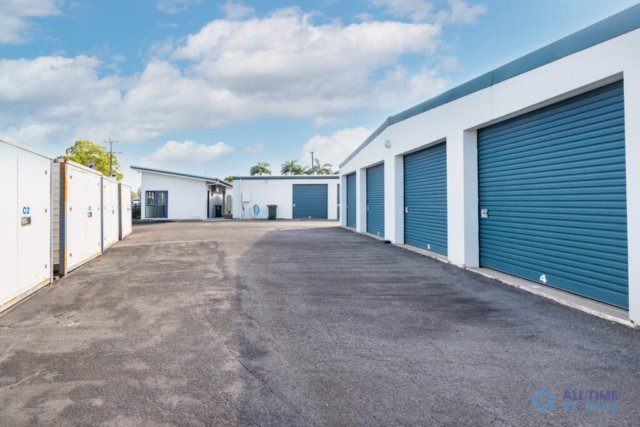 Drive-up storage units with blue roller doors at All Time Storage